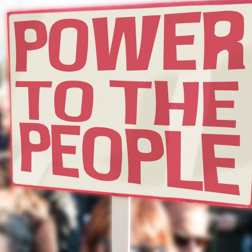 Sign in white and red reading 'power to the people'