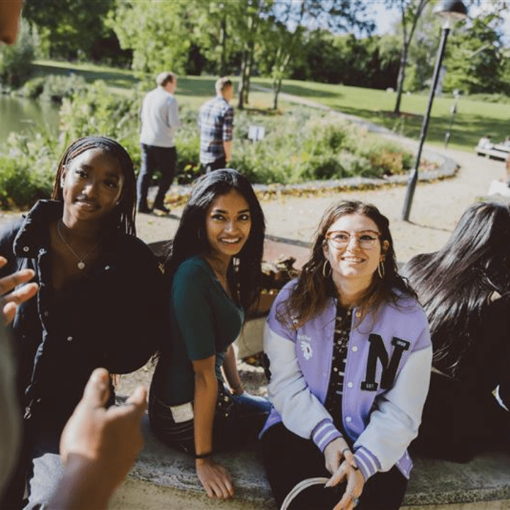 Students smiling by the lake.
