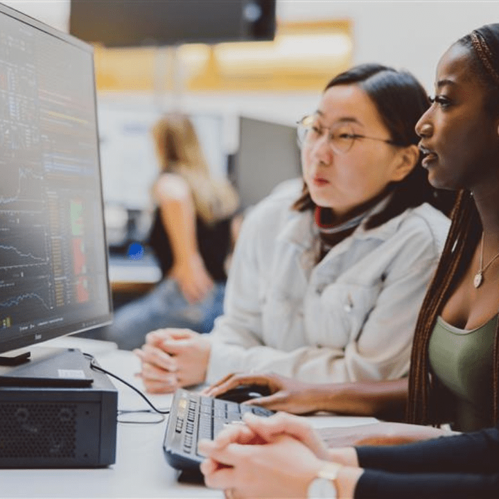 Students gathered round a computer.