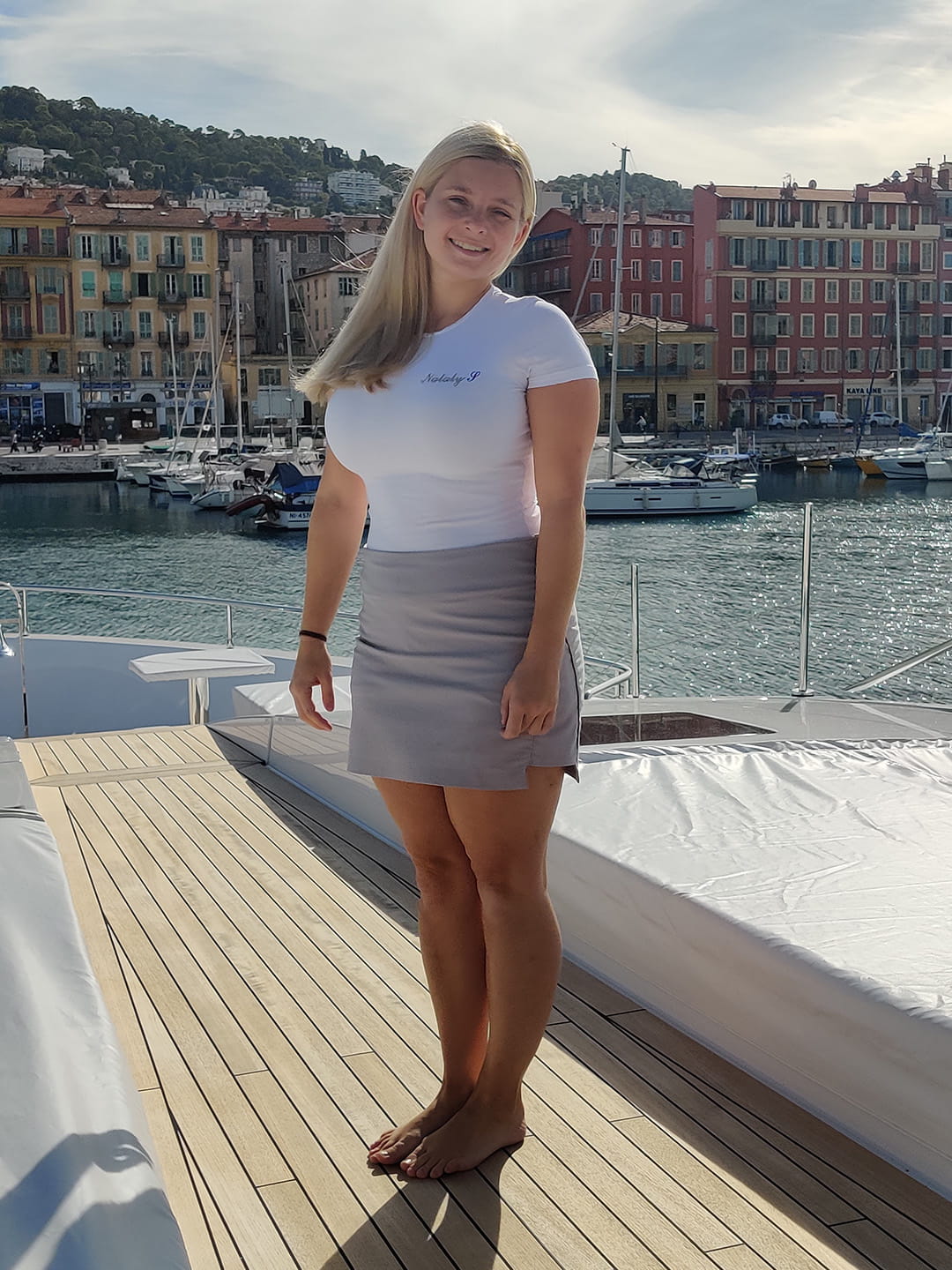 Emily standing on the yacht that she works on.