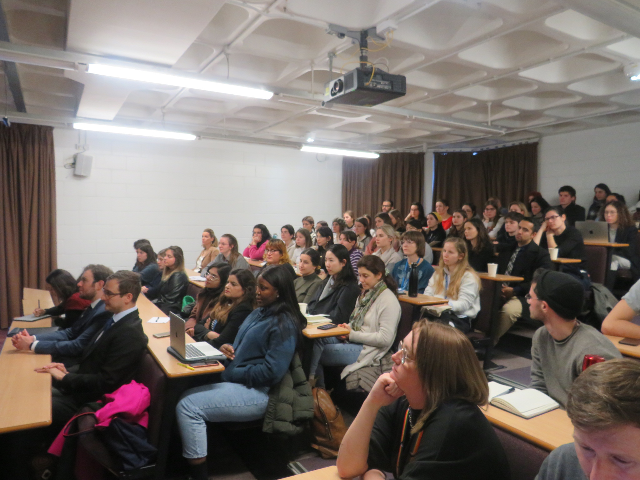 A lecture room full of students watching the lecture