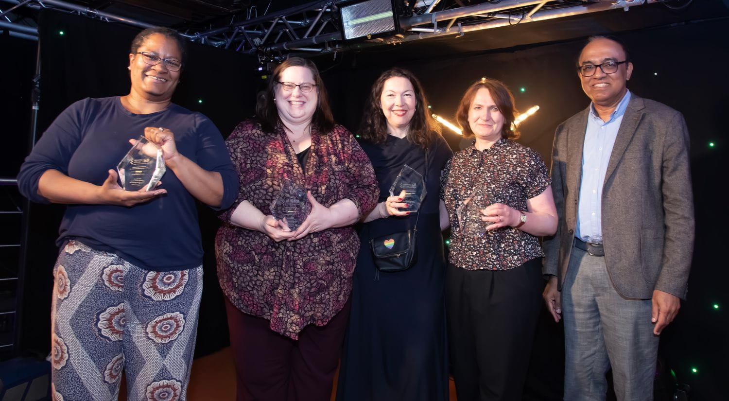 Dr Cara Booker, Dr Laurie James-Hawkins, Professor Roisin Ryan-Flood and Professor Melissa Tyler receive award from Professor Thankom Arun 