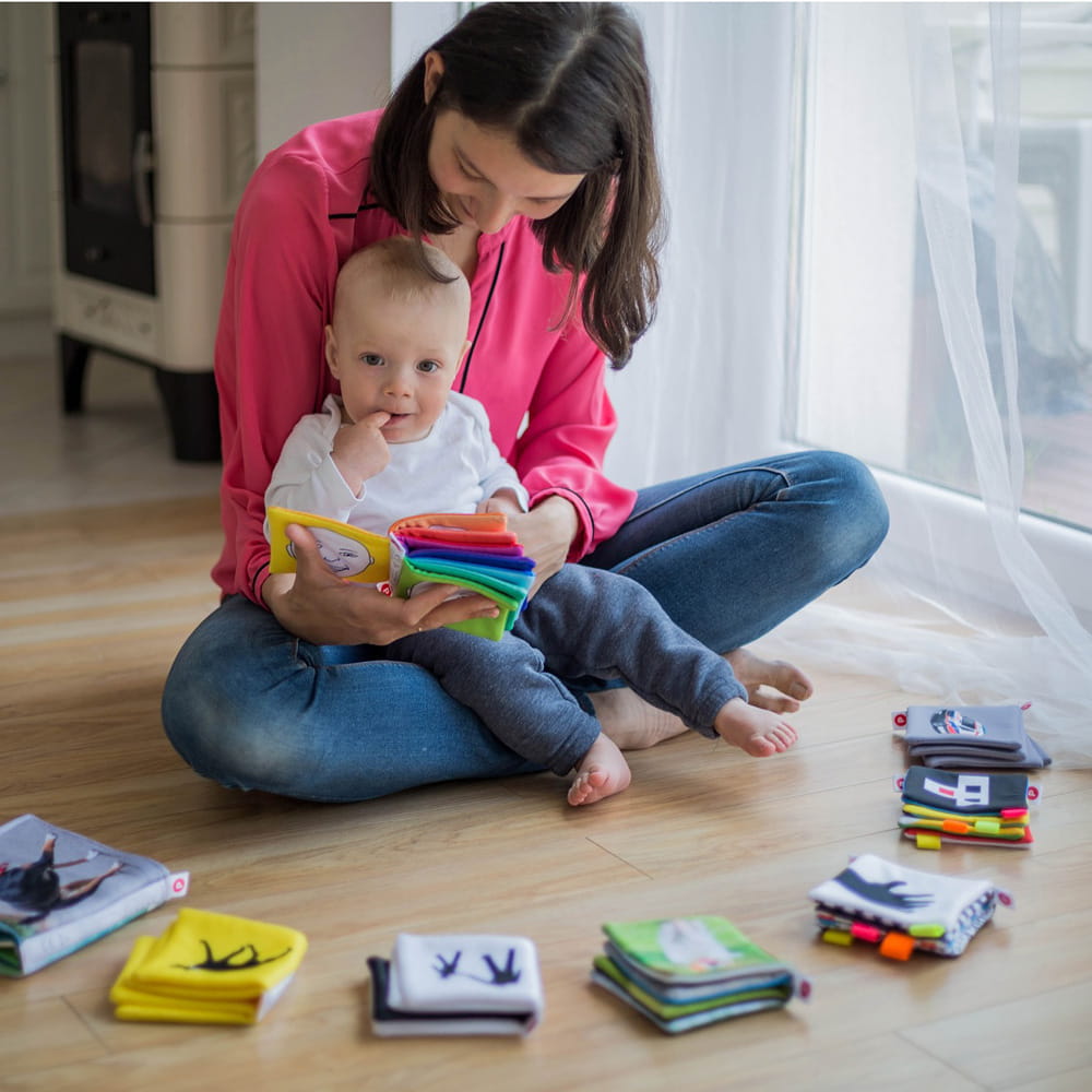 Mother with baby on lap looking at book