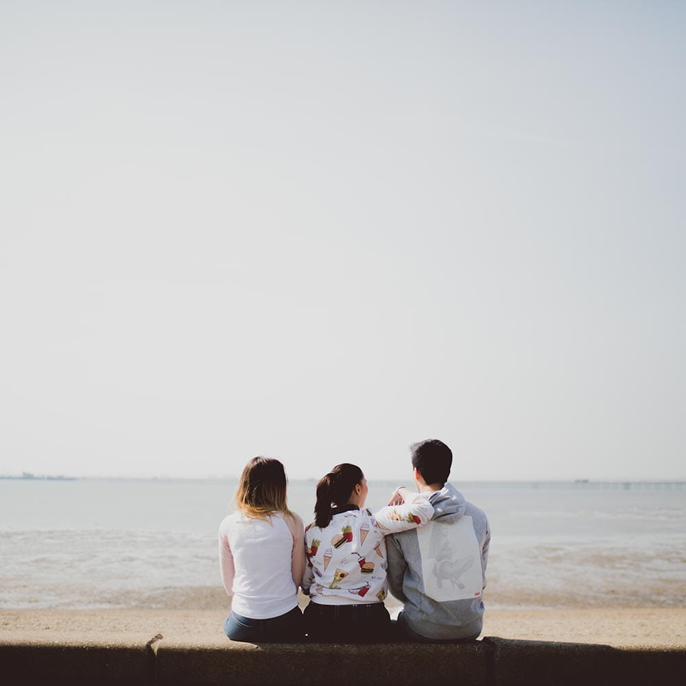 Students sitting on Southend beach