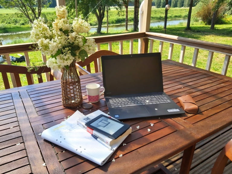 Laptop and study materials on outdoor table