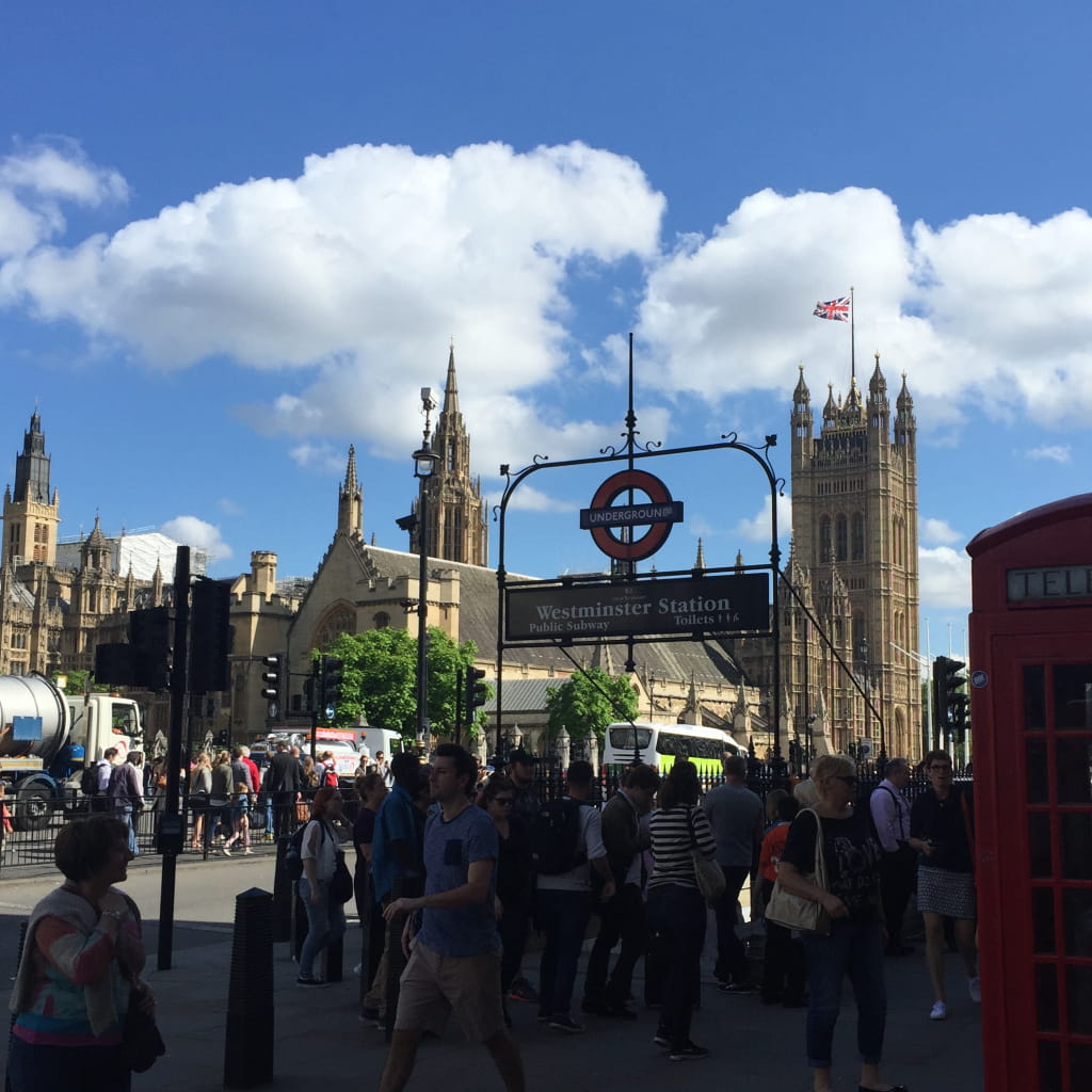 Entrance to Westminster tube station with the Houses of Parliament in the background