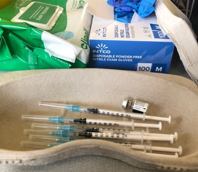 PPE and needles at a vaccination station