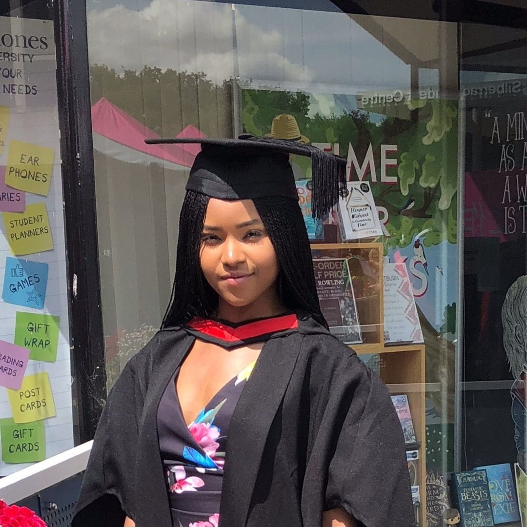 Temini on her graduation day in a cap and gown.