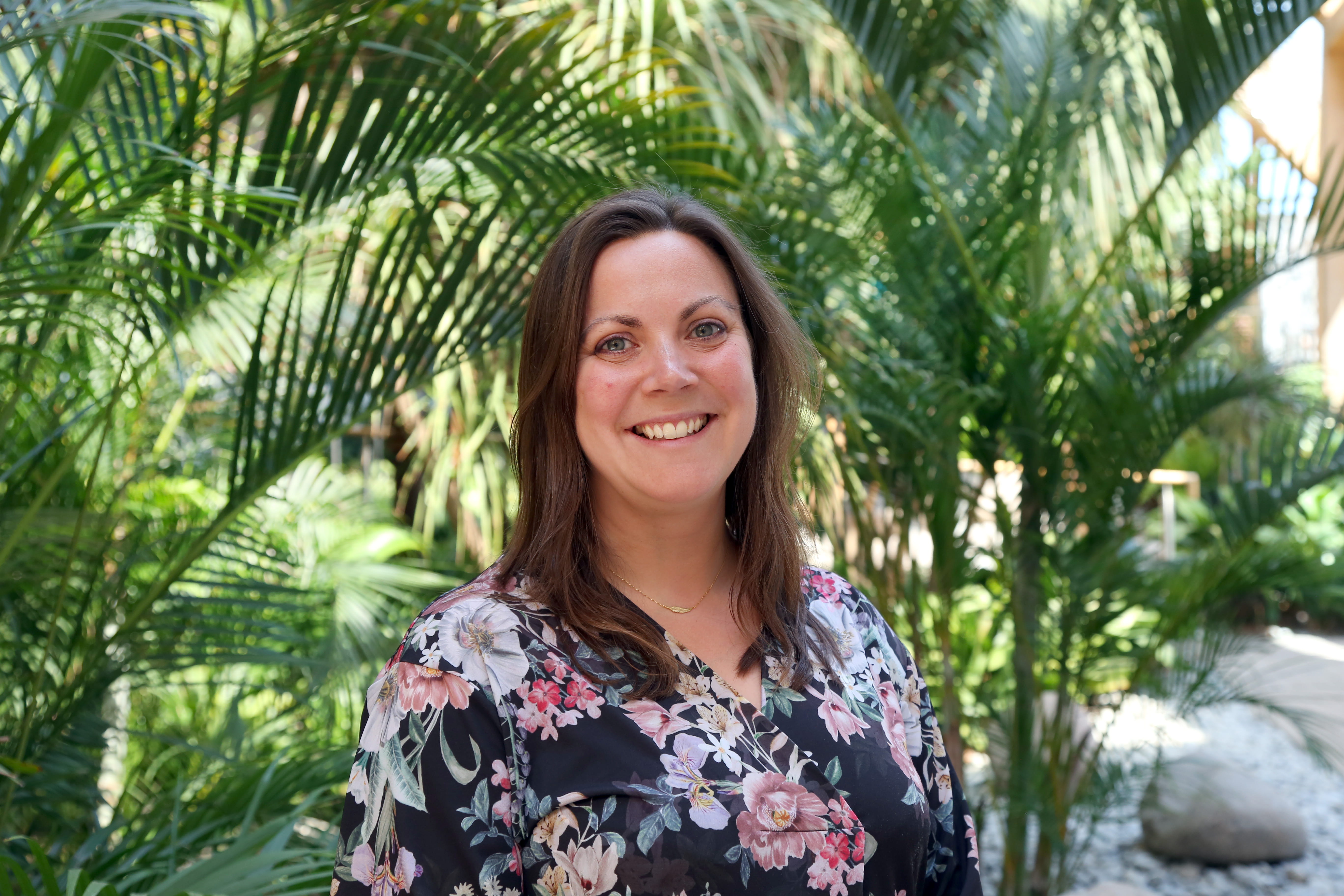 Lydia Wynne Jones student services manager Essex Business School standing in the winter garden