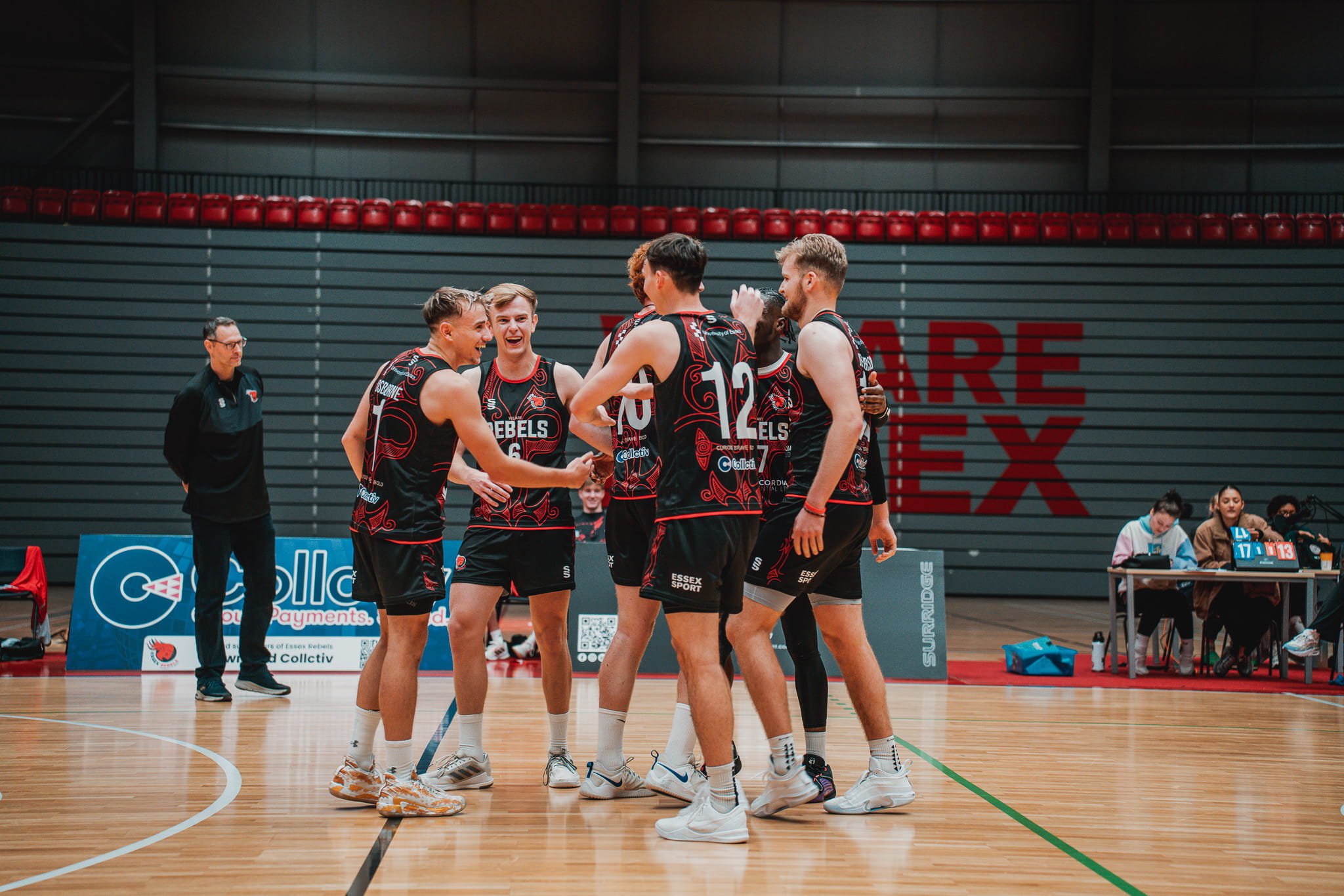 volleyball players celebrating in arena