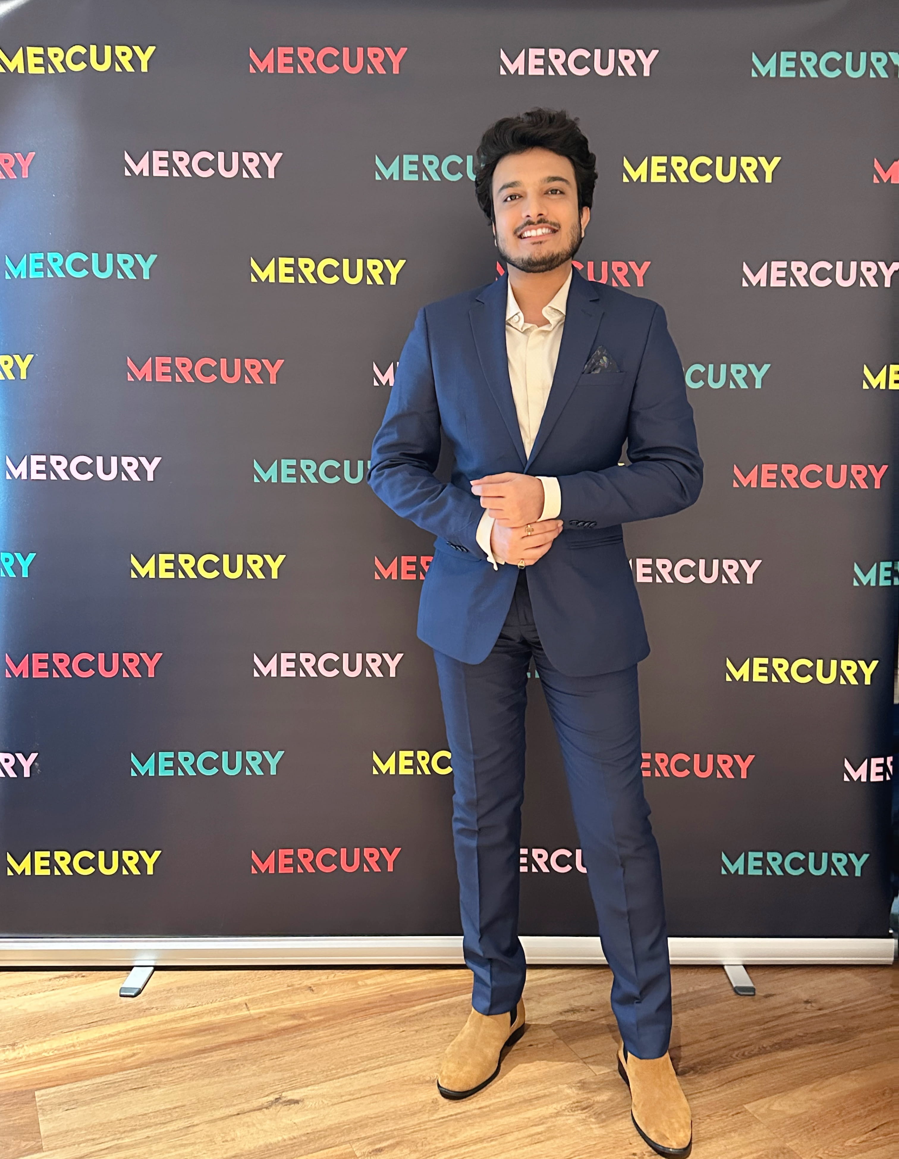 Kushal standing in front of screen that says 'mercury'