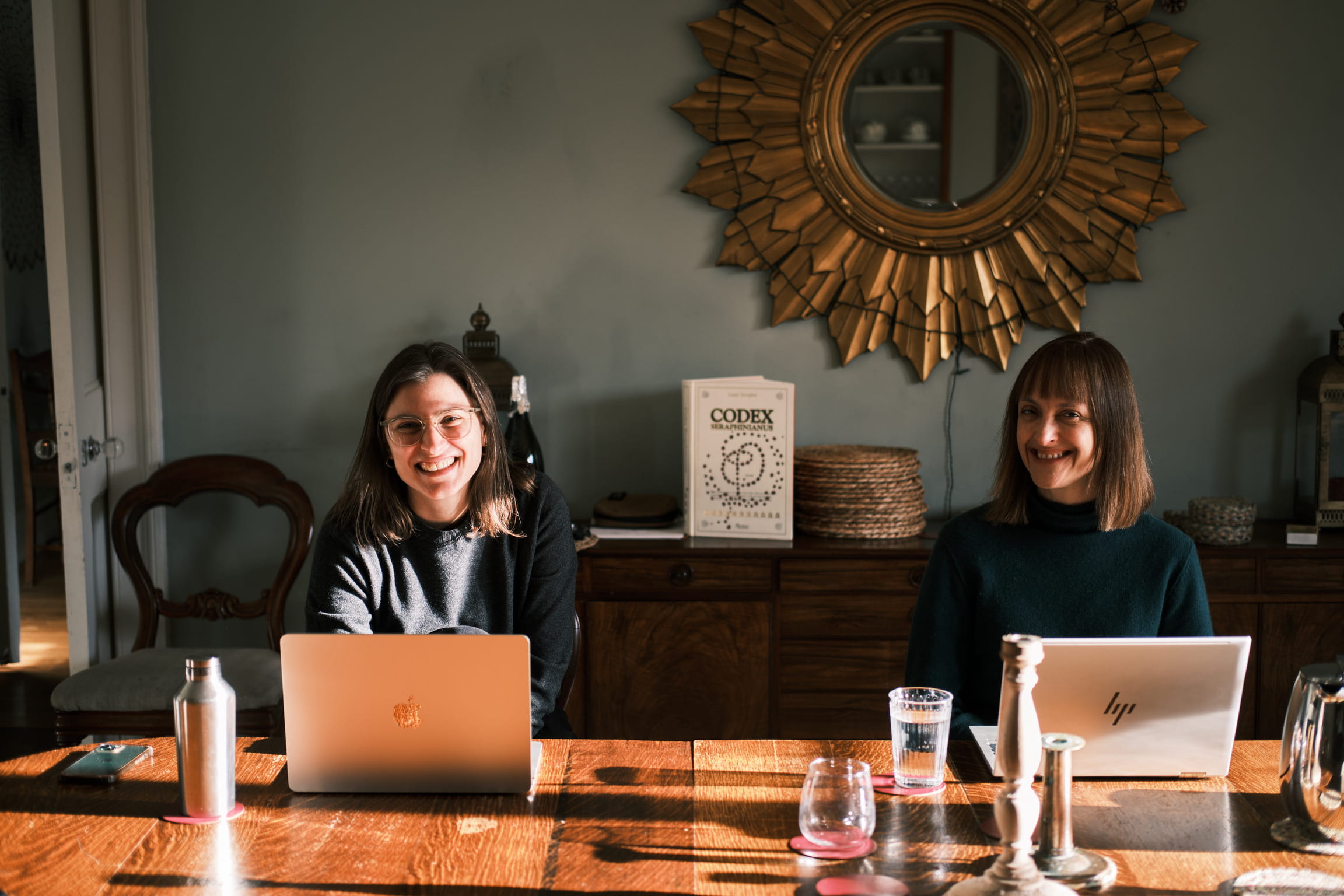 Tara Malfoud with colleague on laptops