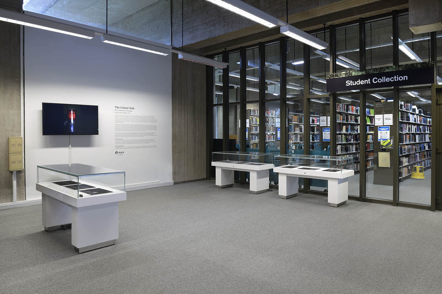 The installation in the Albert Sloman Library showcasing Lucero Del Castillo Ames The Union Club photograph series and short film on the wall