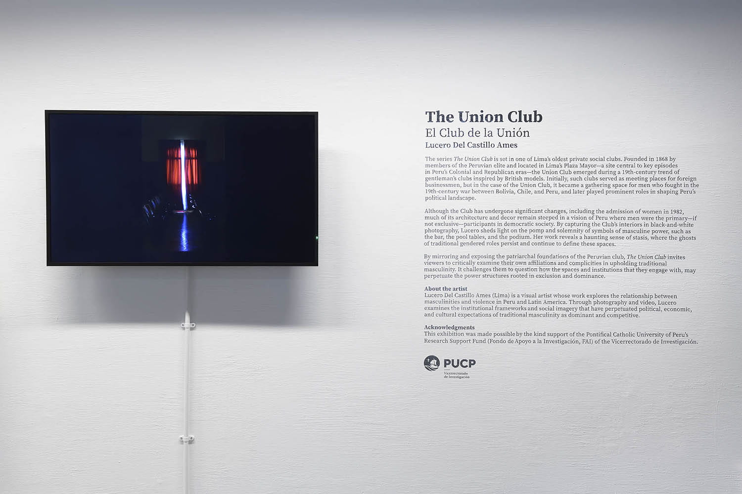 A wall in the Albert Sloman Library with the wall copy for Lucero Del Castillo Ames The Union Club photography series and screen showing her short film The beginning of terror (2023)