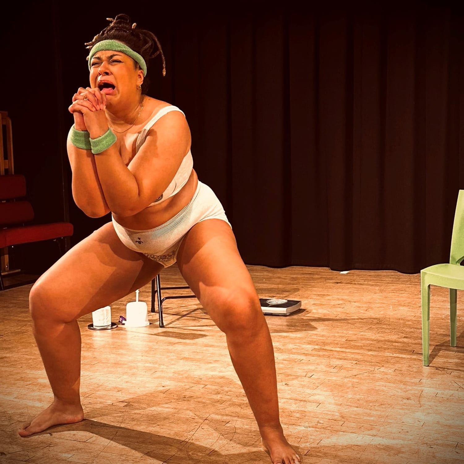 Amy Stephenson-Yankuba performing Nasty on a theatre stage.