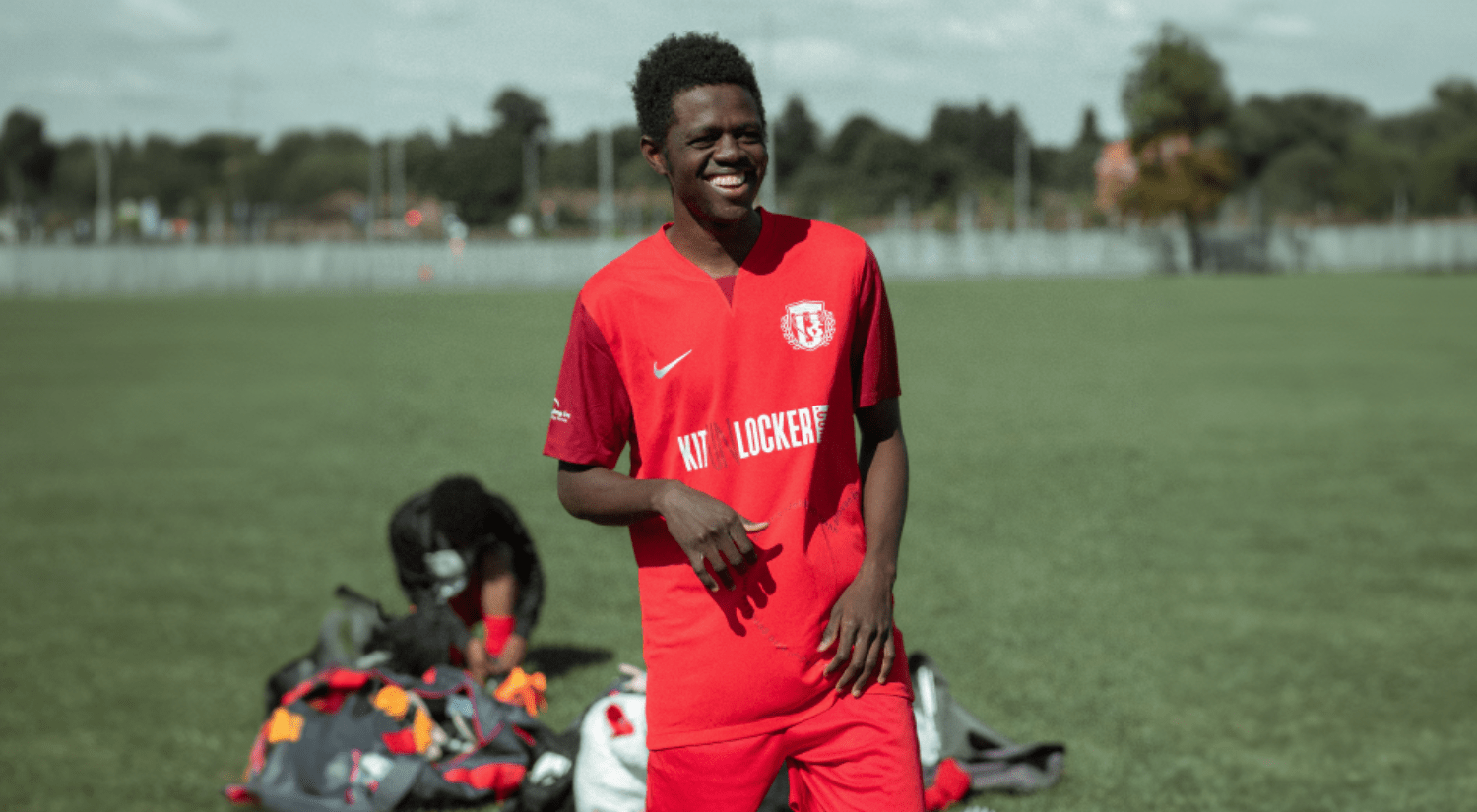 Changing Lives FC player at the side of a football pitch