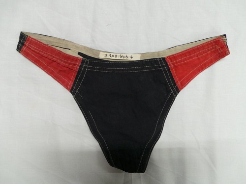 A man's swimming thong from the 1920s, in black and red.