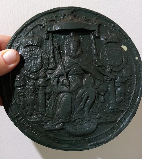 Large black wax seal depicting King James I of England.