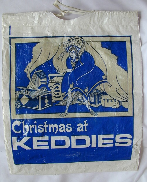 A shopping bag in blue and white, which "Christmas at Keddies" in white text.