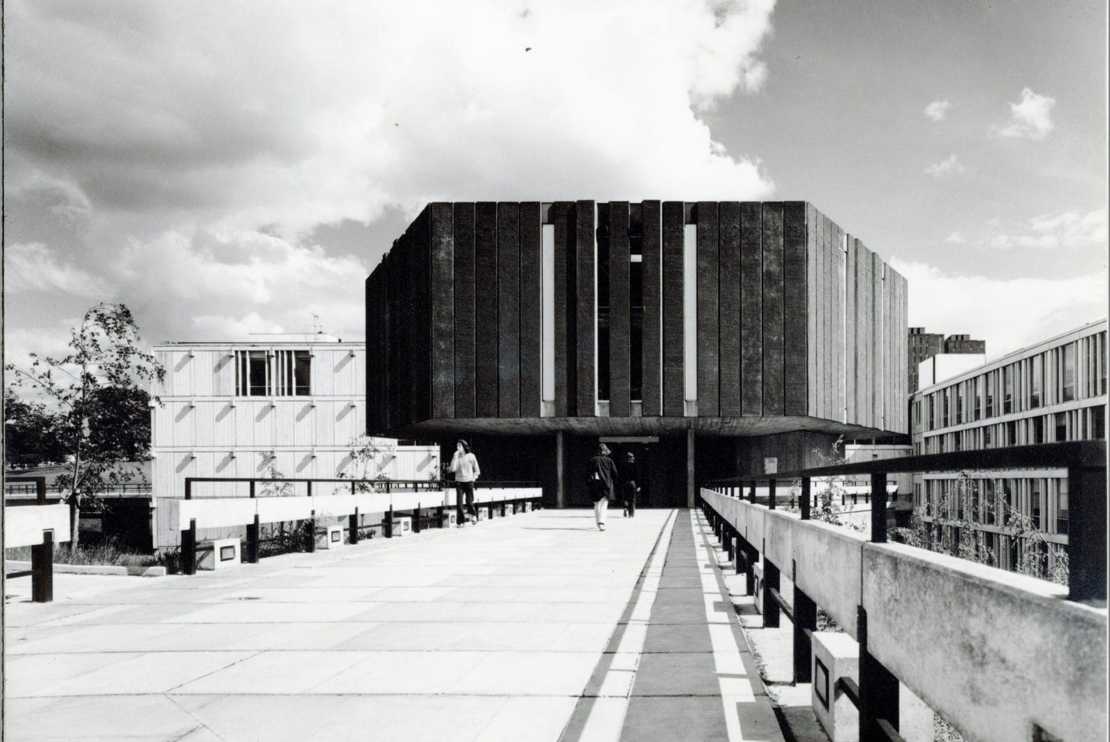 Black and white photograph taken in the early years of the University of Essex. The Hex is a hexagonal shaped building in the style of Brutalist architecture. 