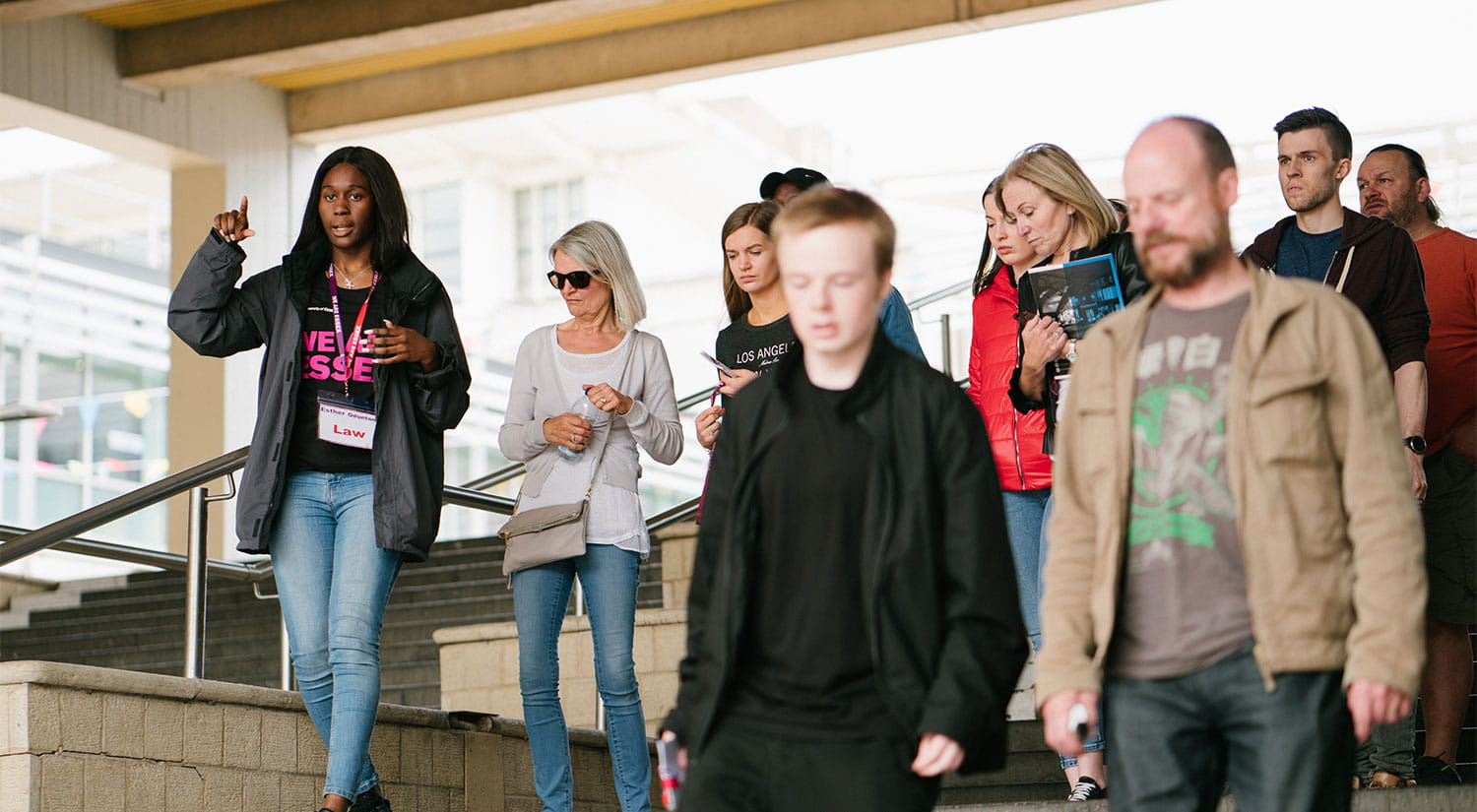 A group of visitors walking through the squares on campus with a student ambassador on a campus tour