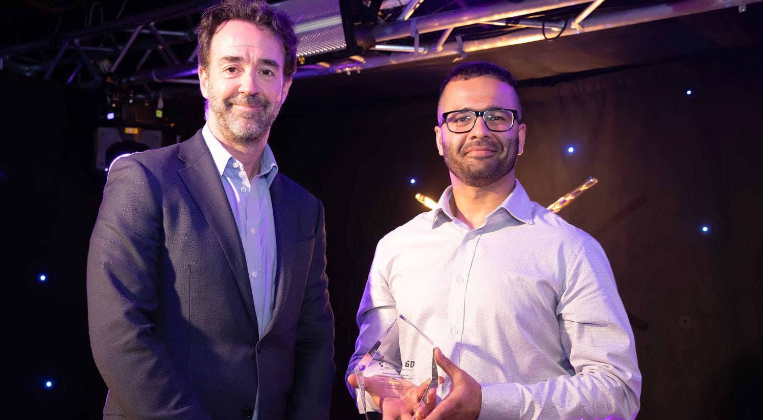 Dr Nikhil Gokani receives award from Professor Chris Grer