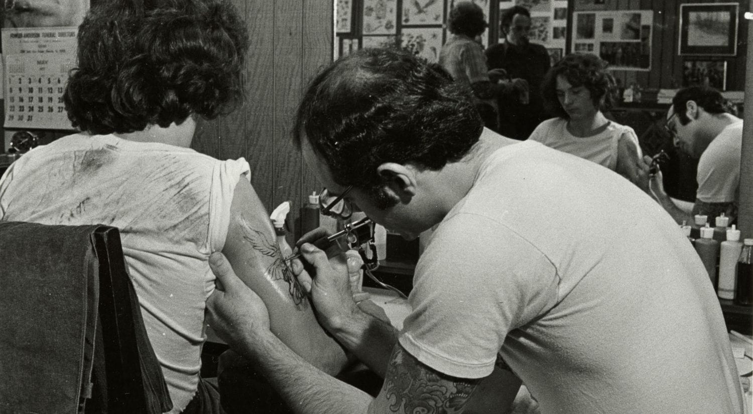 A tattoo artist working in the 1970s, courtesy of Oakland Museum of California. 