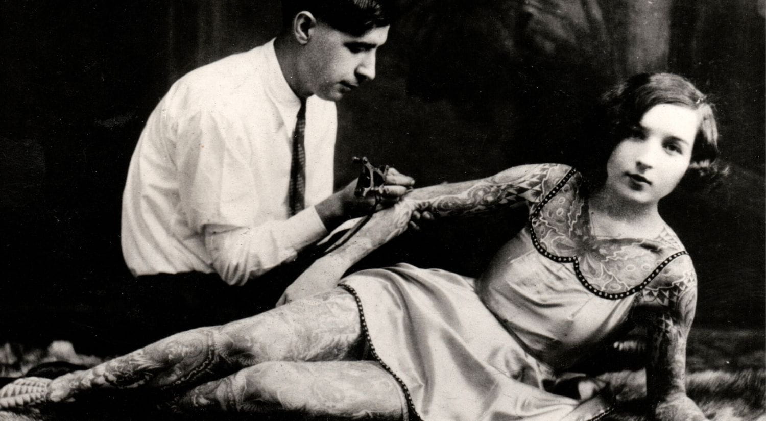 Samuel "Deafy" Grassman tattooing his wife Edith "Stella" Grassman, c.1930s, Rudi Indelder Collection / Bishopsgate Institute.