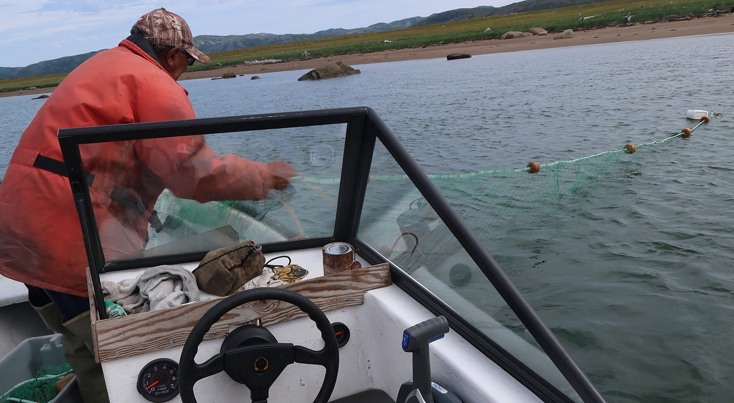 Sam Pijogge checking his net for Arctic Char near Natuashish, 2016